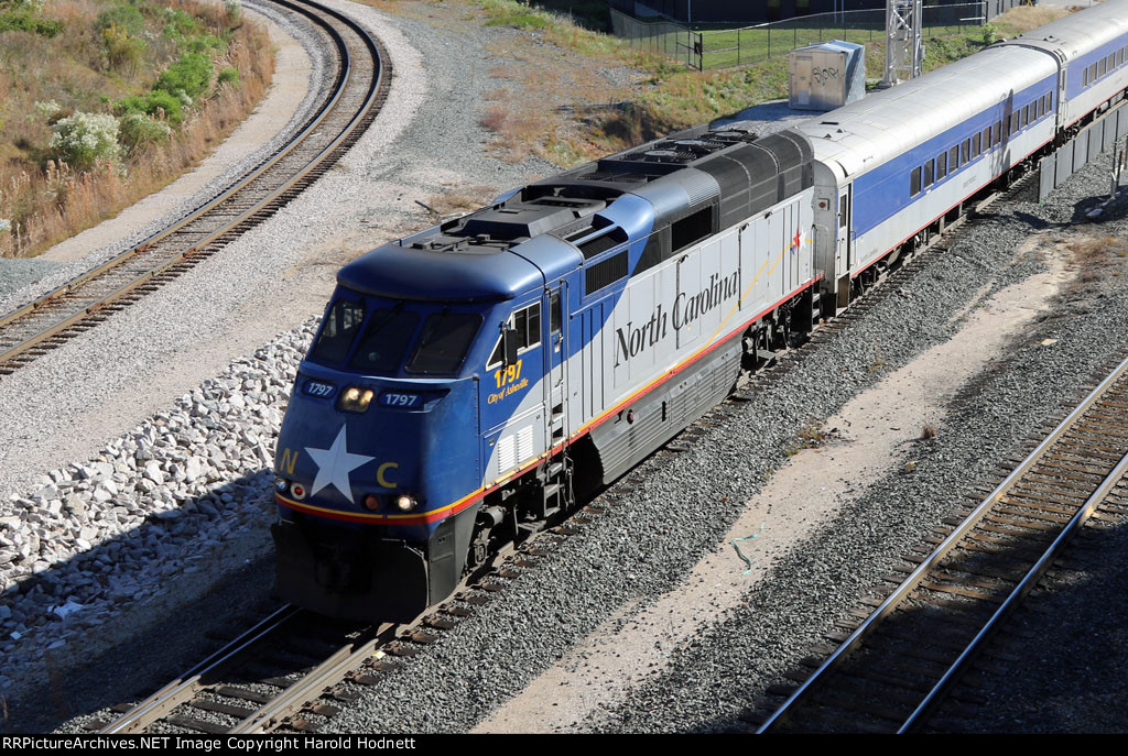 RNCX 1797 leads train P075 away from the station